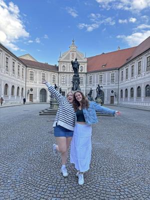 two students posing by a fountain