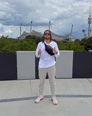 student in front of stadium