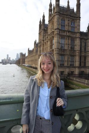 student in front of Parliament