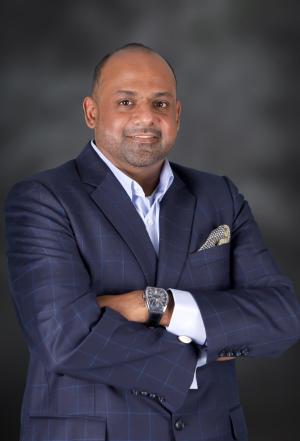 Headshot of male wearing a suit with no tie