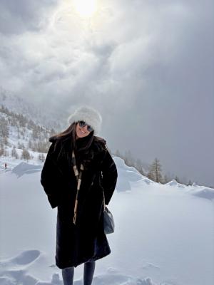 student posing on a snowy mountainside