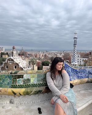 student posing above a city