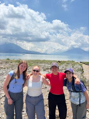 Students hugging near a lake