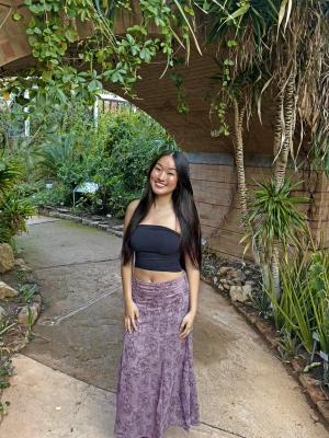 student posing in courtyard