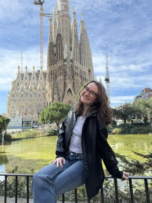 Student posing near large cathedral