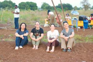 students sitting in dirt