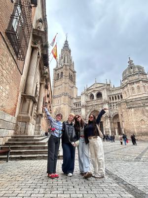 students posing in a brick courtyard