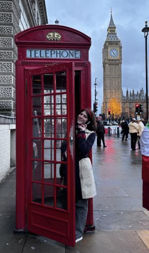 student using phone booth in London