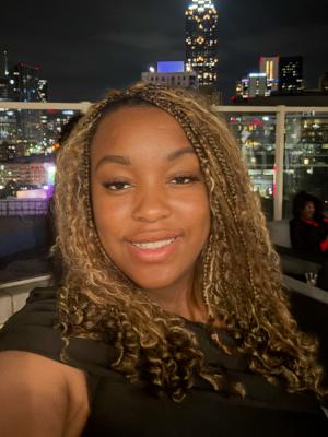 Outdoor portrait of female with braids.