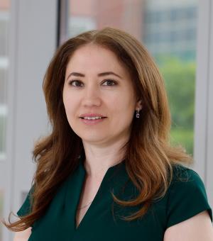 Professional headshot of woman wearing green dress